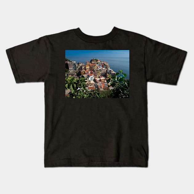 View on the cliff town of Manarola, one of the colorful Cinque Terre on the Italian west coast Kids T-Shirt by Dolfilms